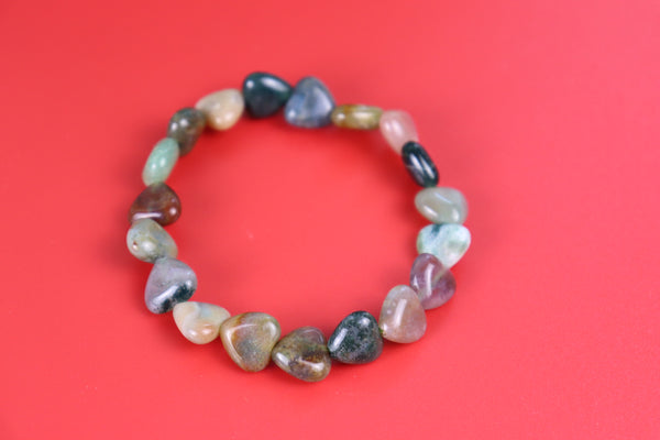 Multicolored agate heart shaped  beaded bracelet on a red background