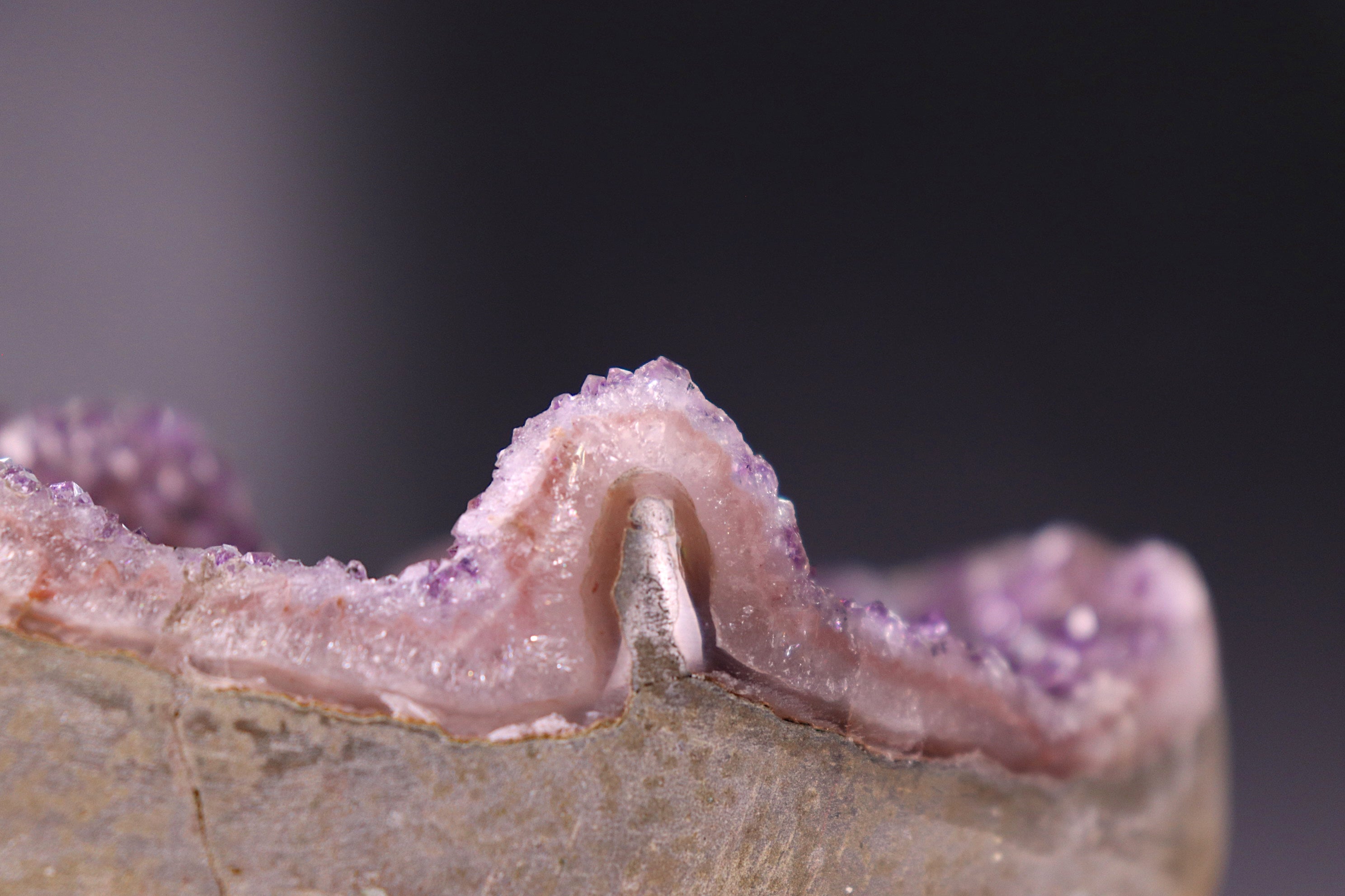 Close-up of a geode with crystals inside on a dark background