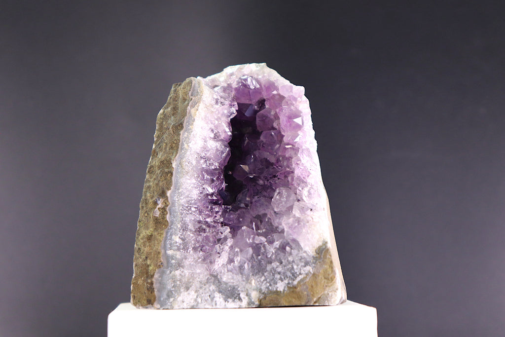 Amethyst crystal on a gray background