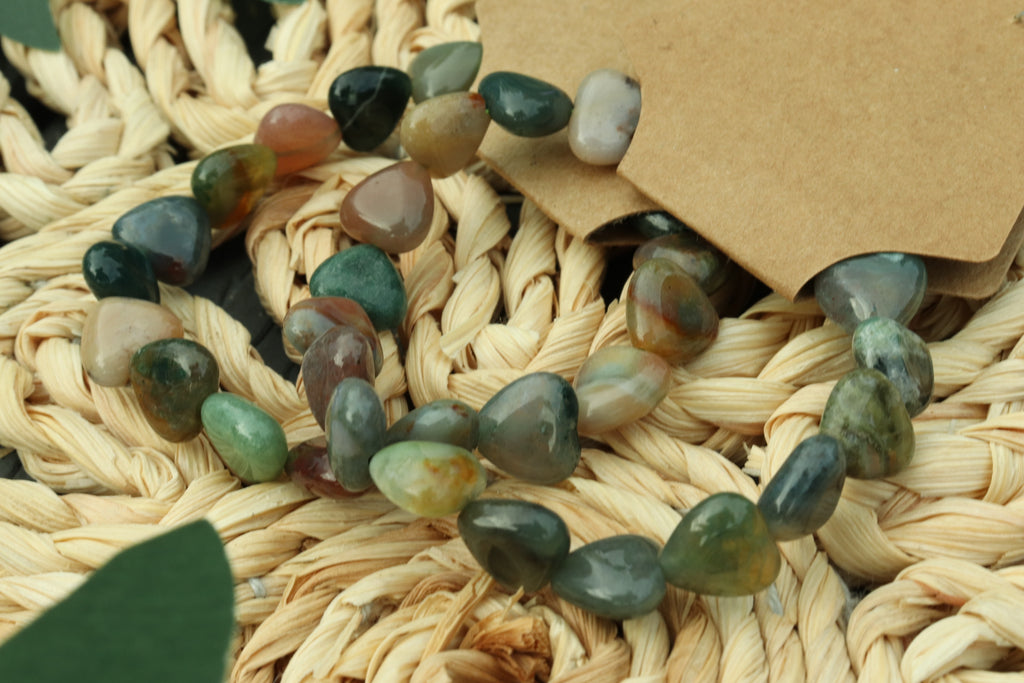 Mixed Agate Heart shaped beads bracelet on a woven surface