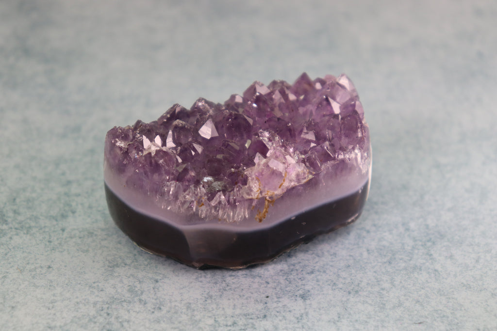 Amethyst crystal on a gray background