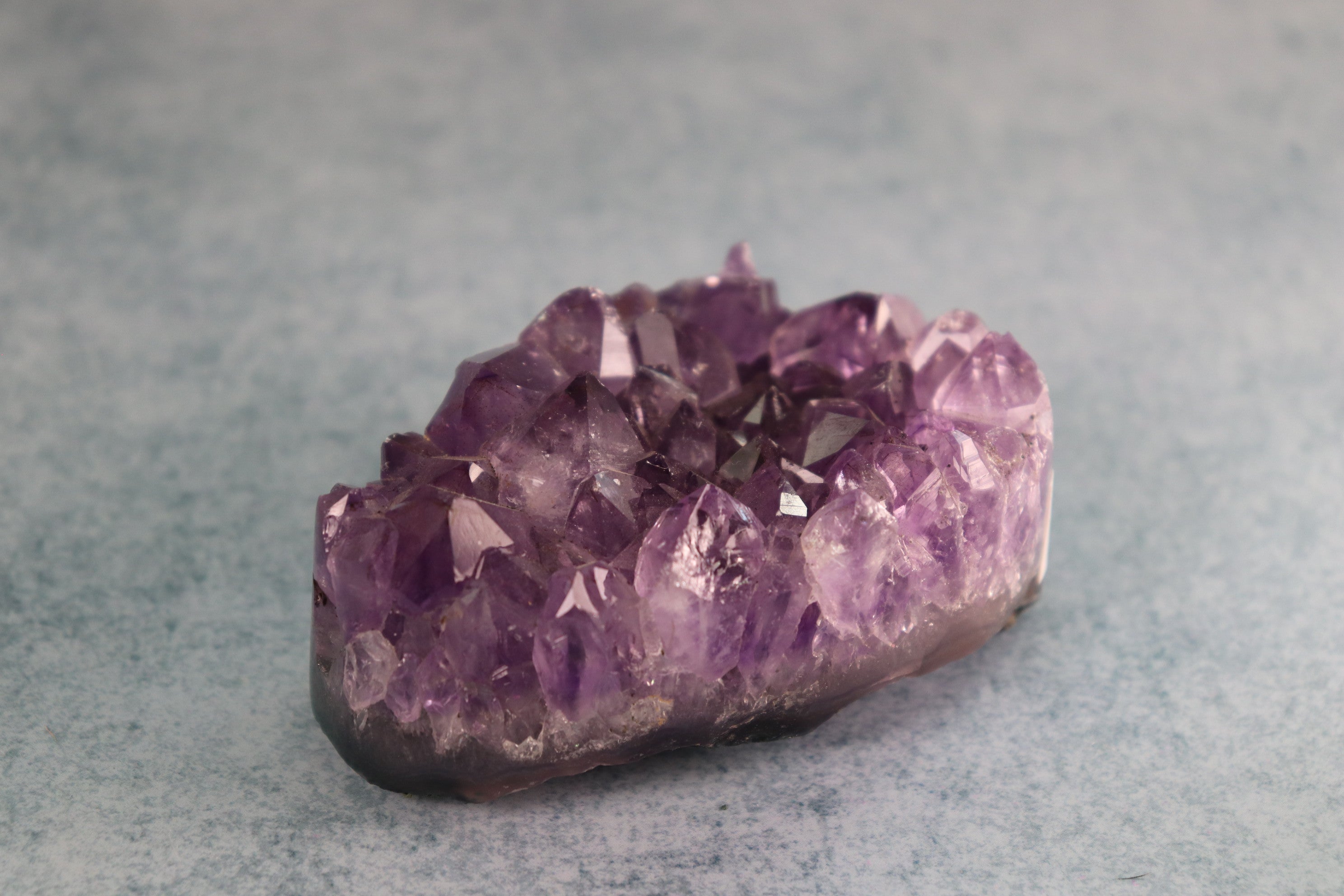 Amethyst crystal on a gray background