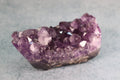 Amethyst crystal cluster on a gray background