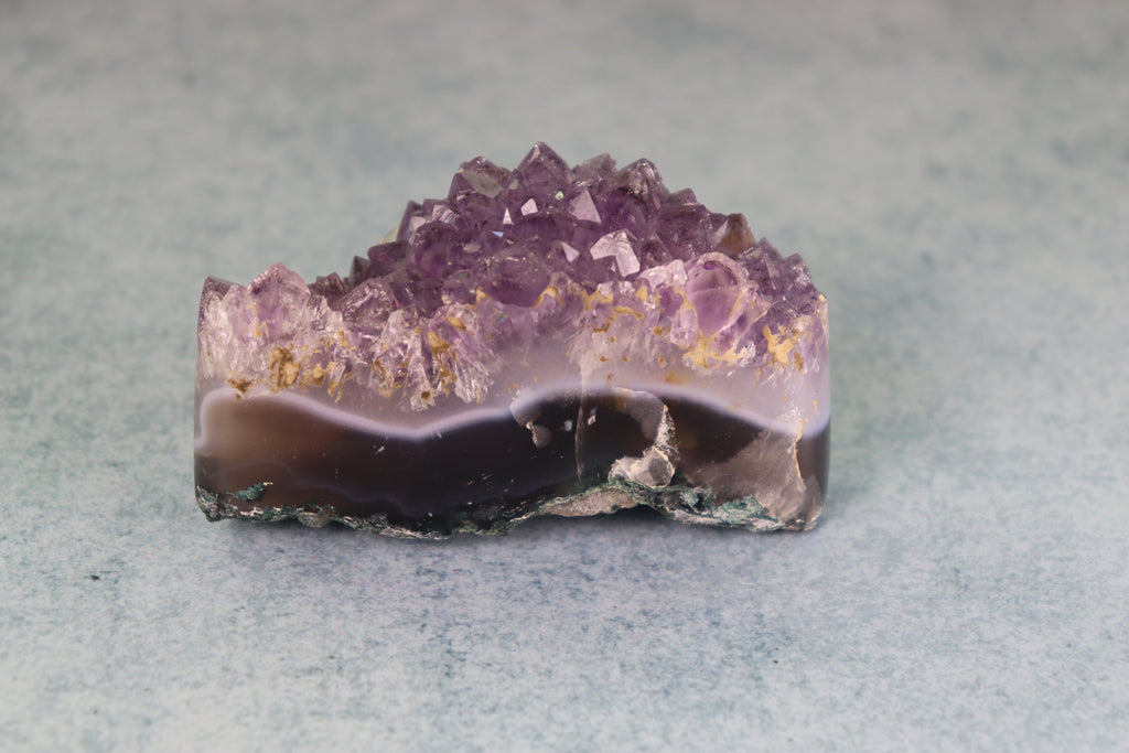Amethyst crystal on a light gray background