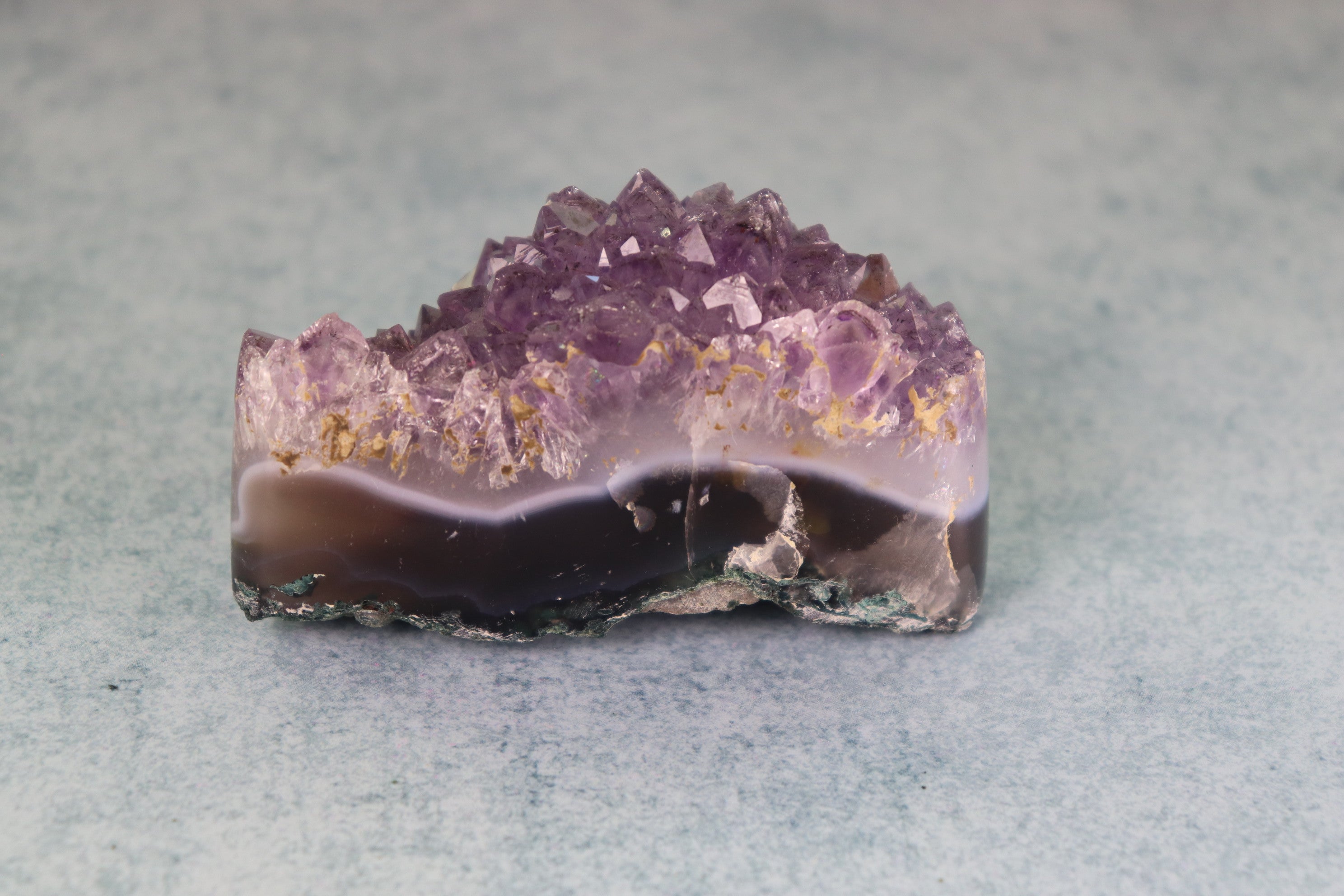 Amethyst crystal on a light gray background