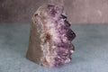 Amethyst crystal on a gray background