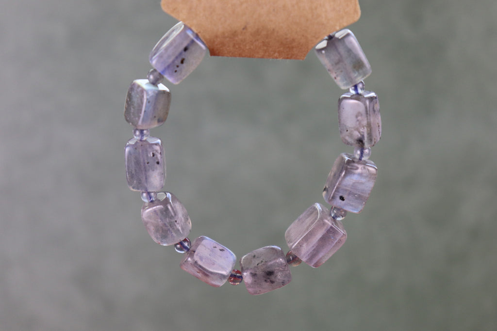 Labradorite bracelet against a gray background