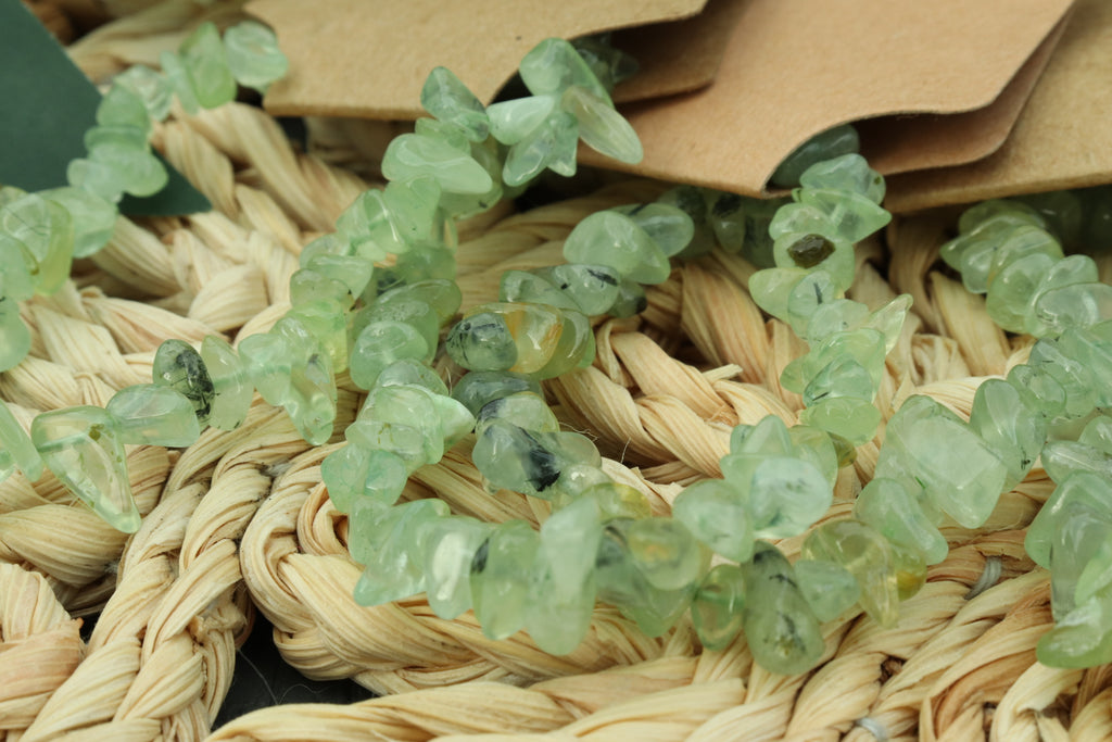 Green crystal prehnite bracelet on a woven surface