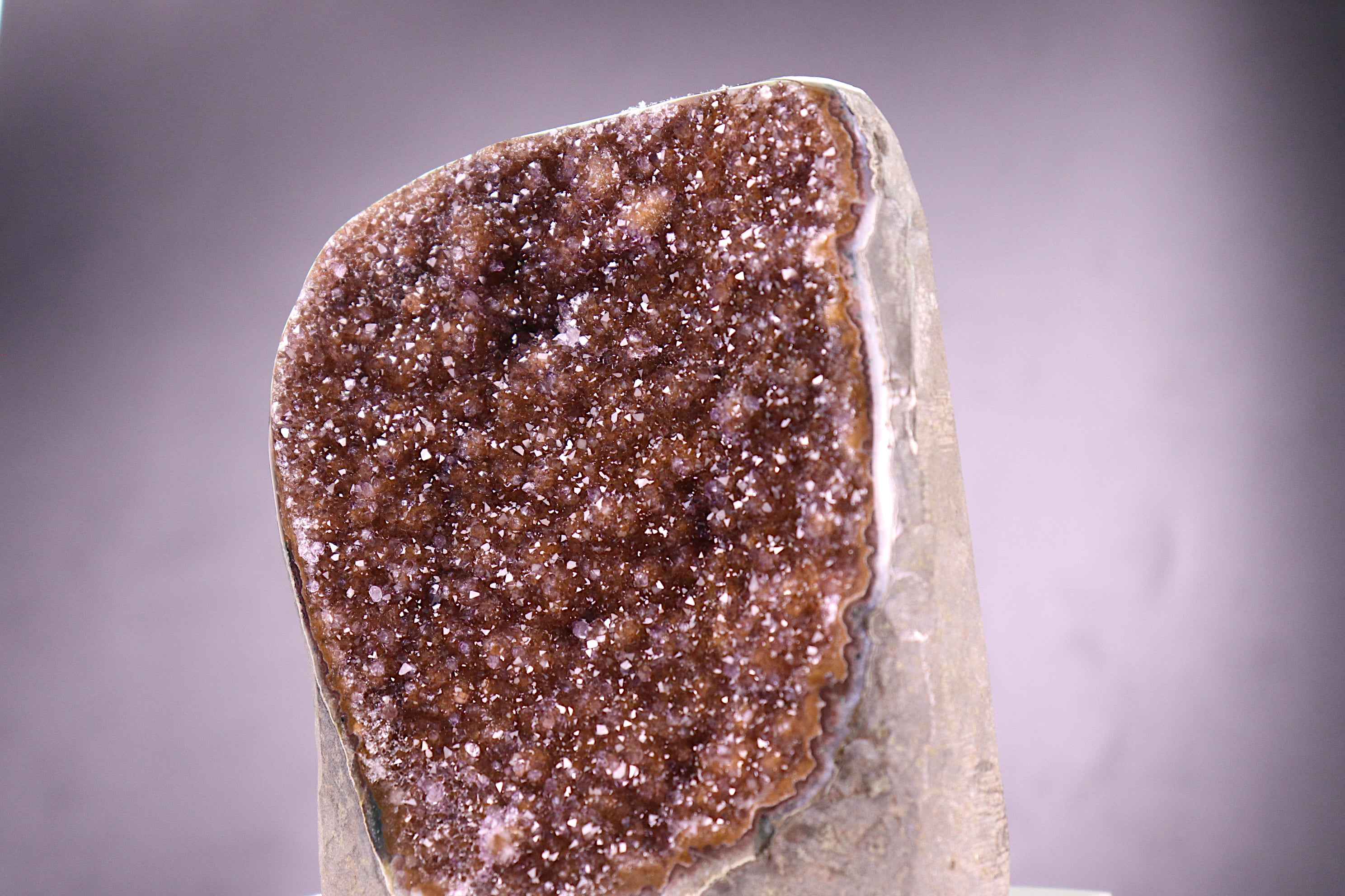 Close-up of a amethyst specimen on a gray background