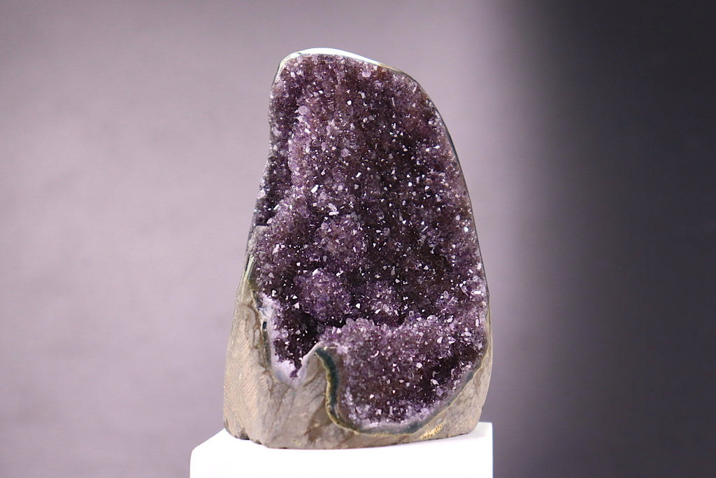 Amethyst crystal on a gray background