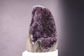 Amethyst crystal on a gray background