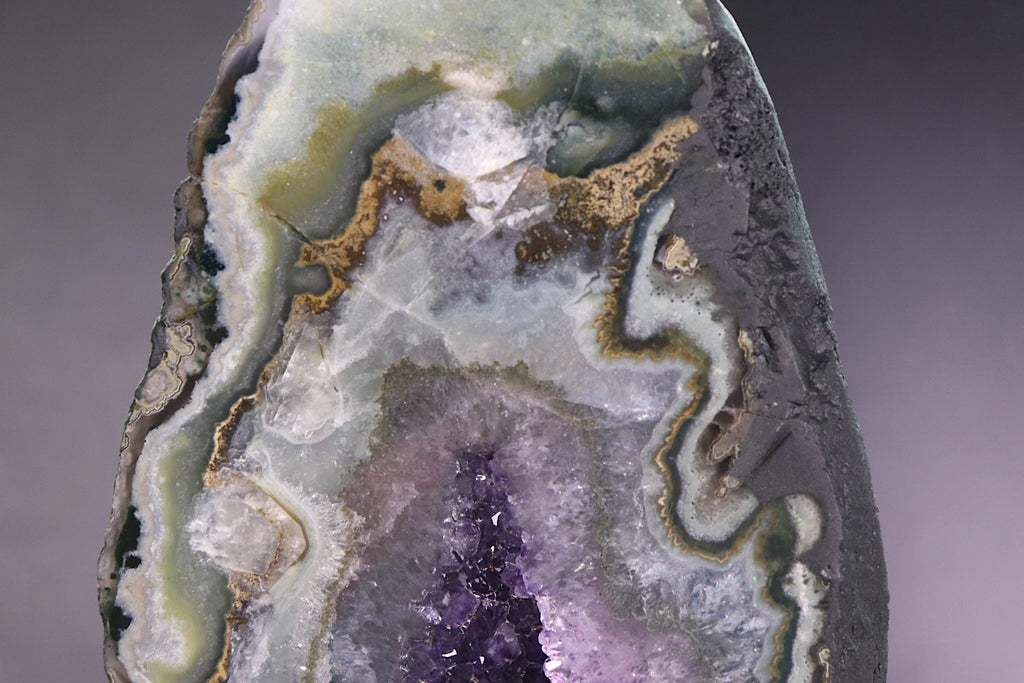Close-up of a multicolored agate stone with amethyst as its core
