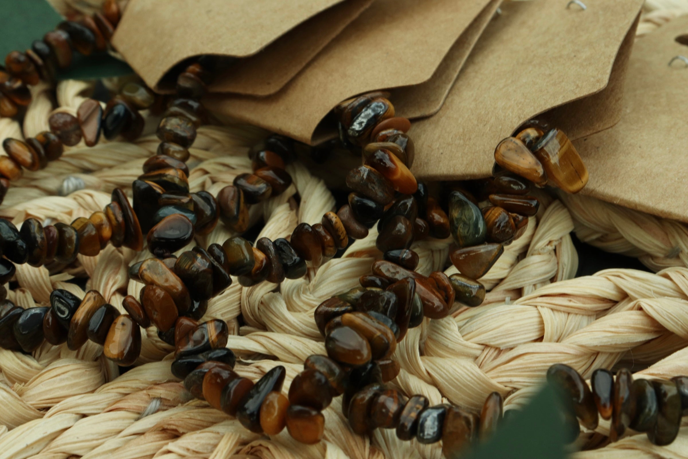 Brown beaded tigers eye bracelet on a woven surface 
