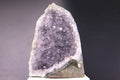 Amethyst crystal on a gray background