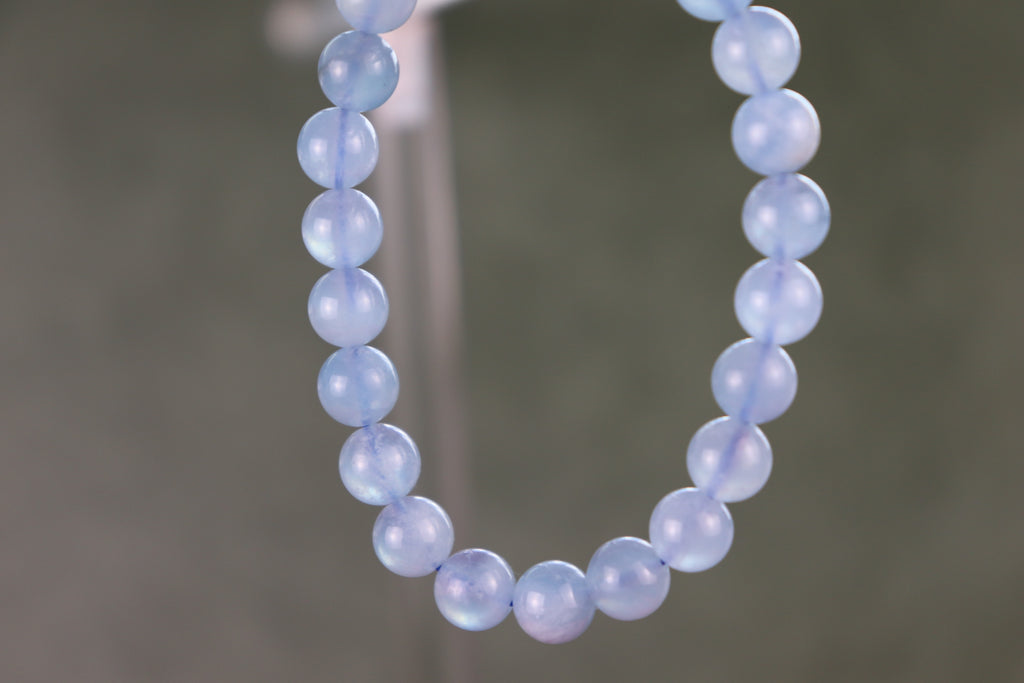 aquamarine beaded bracelet with a gray blurred background