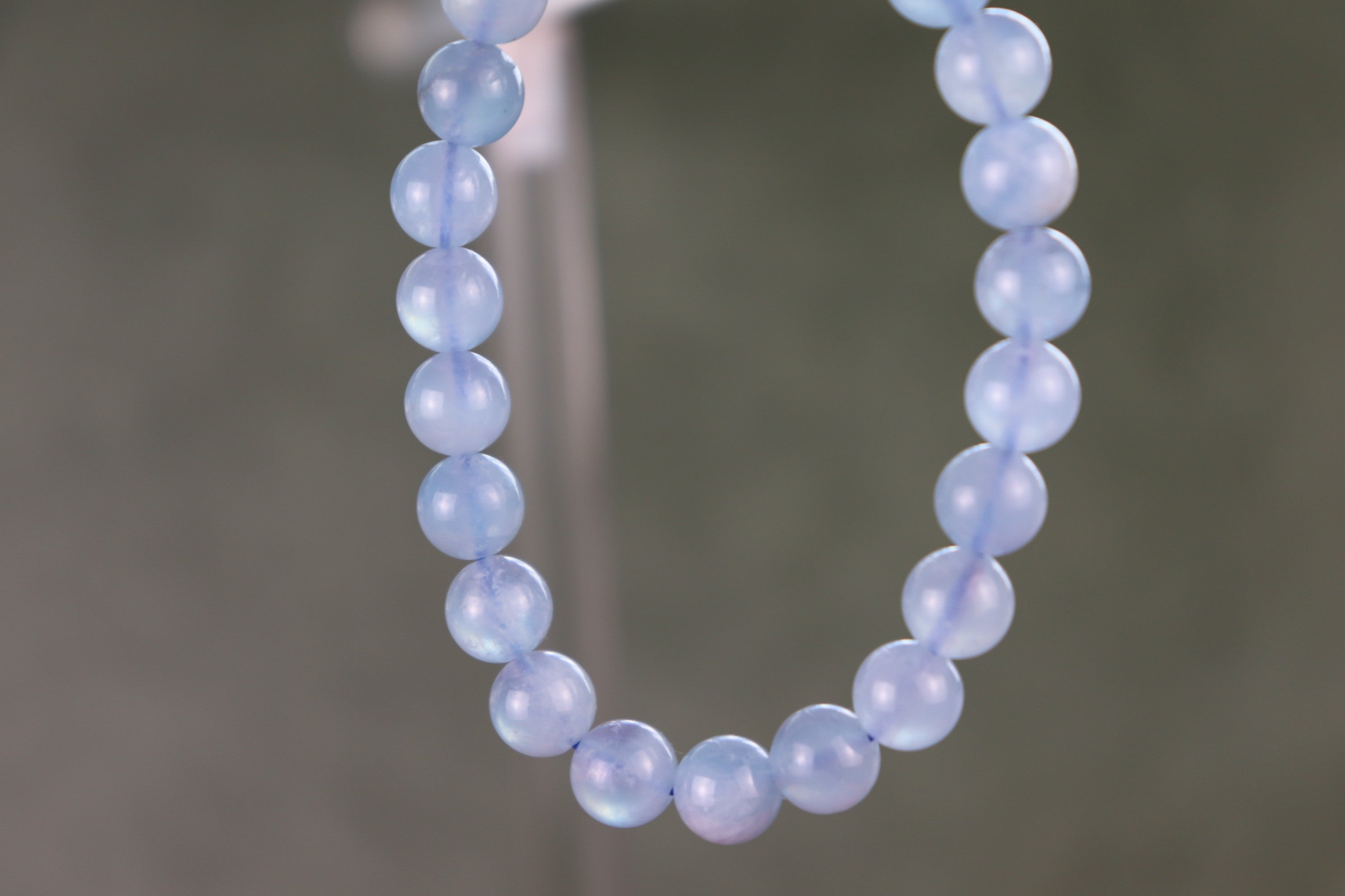 aquamarine beaded bracelet with a gray blurred background