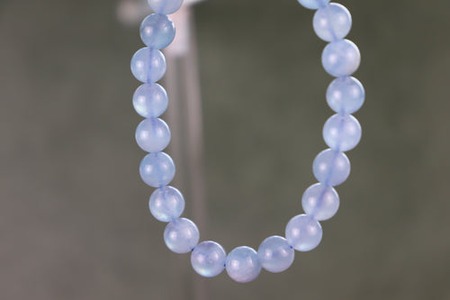 aquamarine beaded bracelet with a gray blurred background