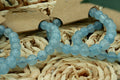aquamarine beaded bracelet on a woven surface 
