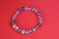 Auralite 23 beaded bracelet on a red background