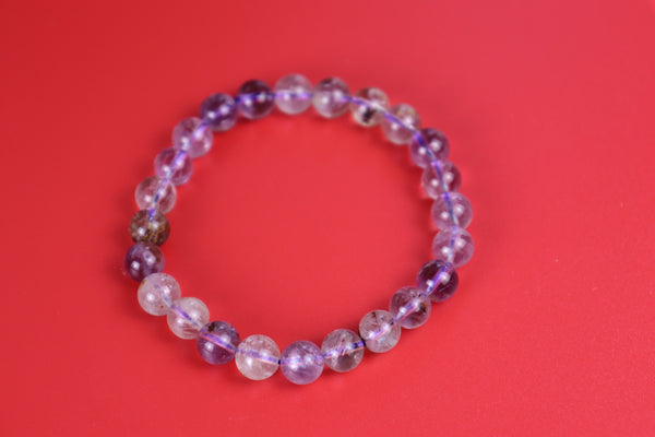 Auralite 23 beaded bracelet on a red background