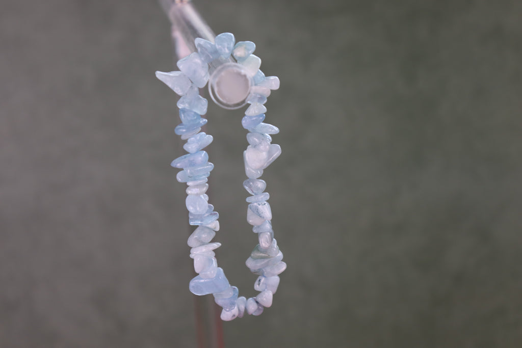 Blue lace agate chip bracelet on a dark background