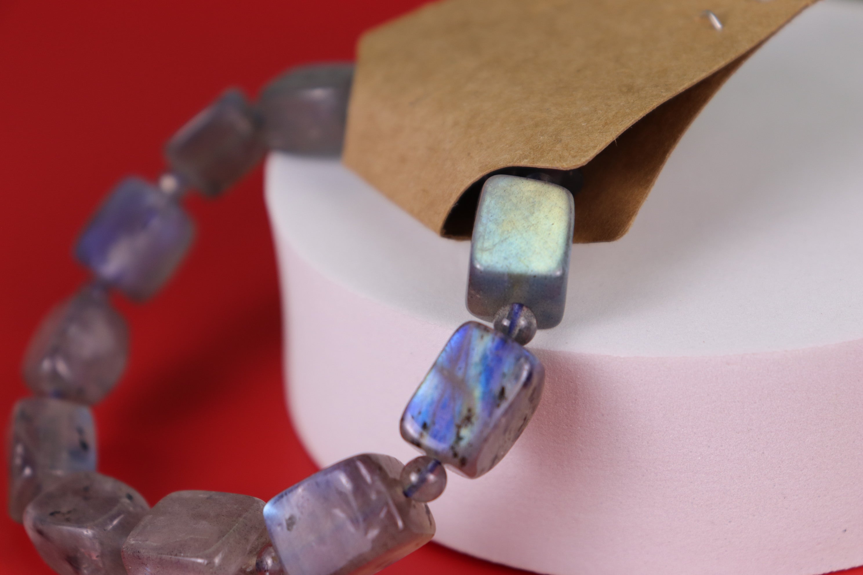 Labradorite Bracelet with irregularly shaped beads on a red background