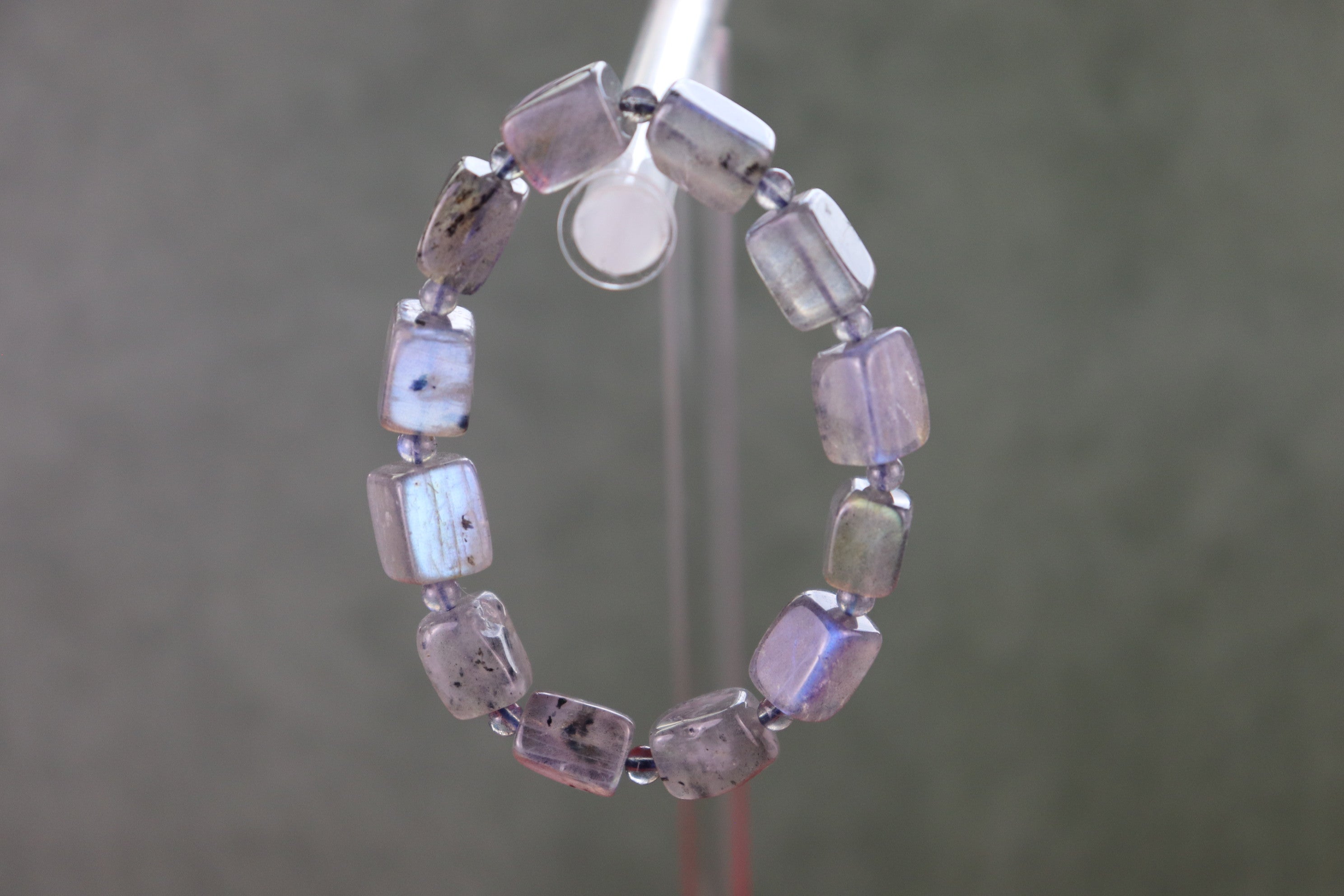 Labradorite bracelet on a stand with a neutral background