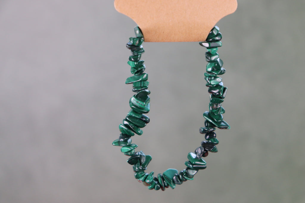 Green malachite chip bracelet on a gray background
