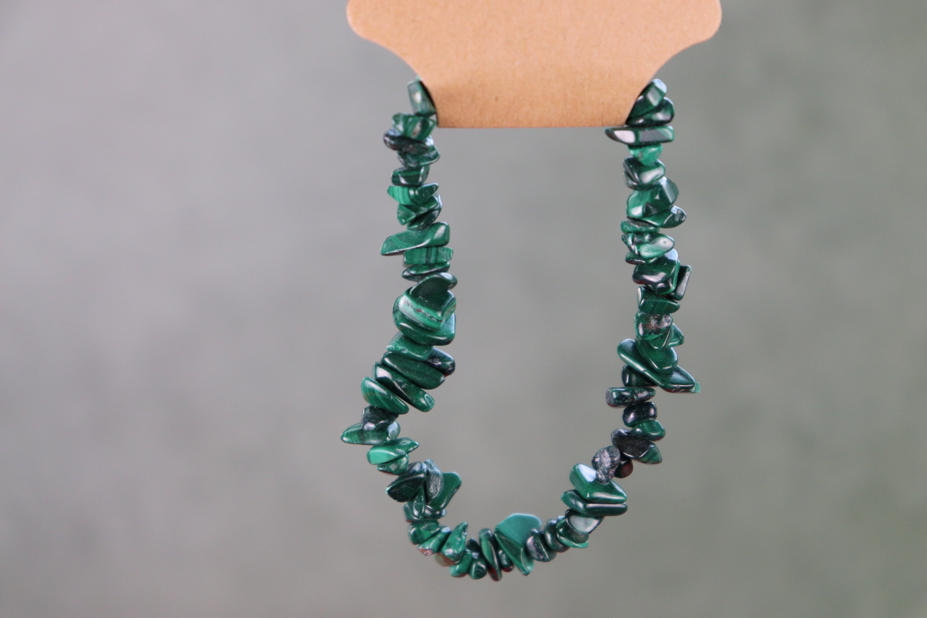 Green malachite chip bracelet on a gray background
