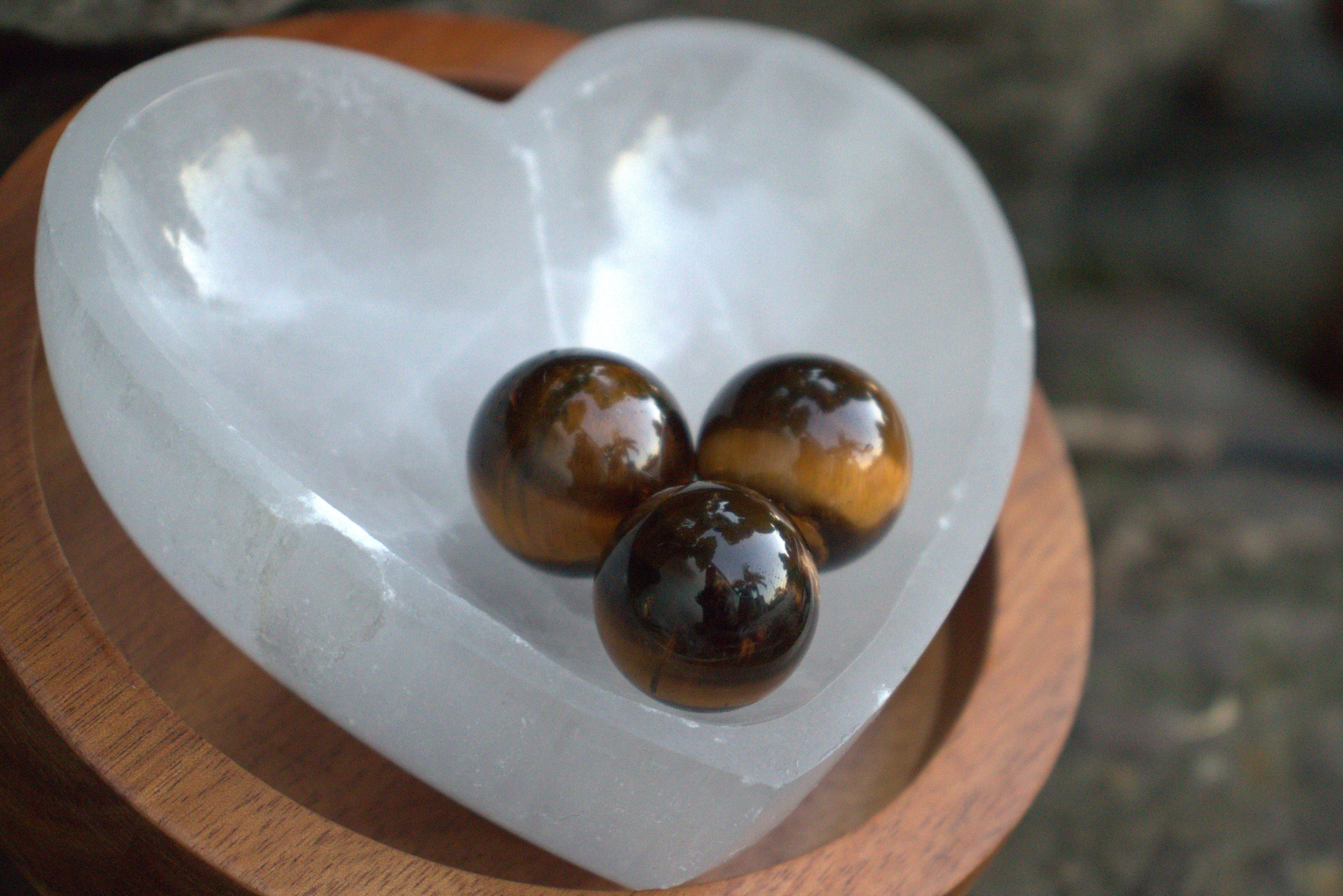 Three tiger's eye stones on a heart-shaped crystal